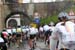 The peloton climbs through a village