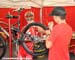 Burry Stander watches as the mechanic shaves down the knobs on his tires
