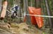 Joe Smith blasting out over a root choked rut in hopes of getting a few hundredths of a second more.  		CREDITS:  		TITLE: UCI 2012 MTB World Championships 		COPYRIGHT: �� Colin Meagher